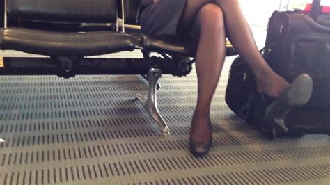 Candid flight attendant dangling shoeplay
