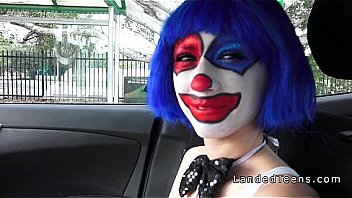 Girl wearing clown mask gives