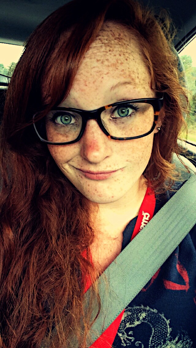 Freckled redhead with glasses making